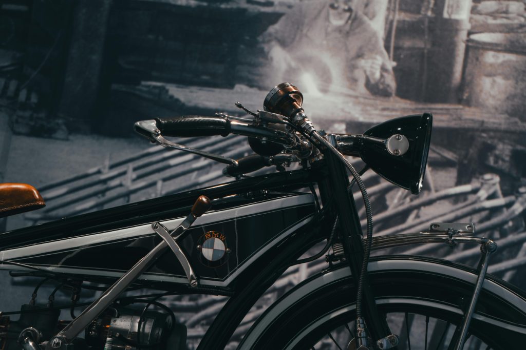 Close-up of a vintage BMW motorcycle displayed in a museum, showcasing classic design features.